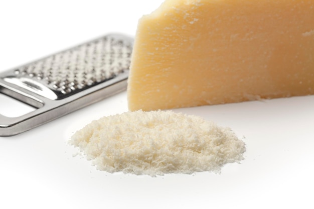 Portion and grated Parmesan cheese on white background