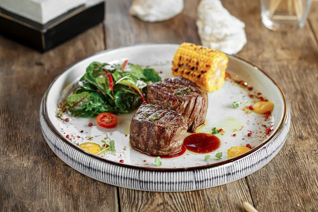 Portion of grilled fillet mignon steak with corn