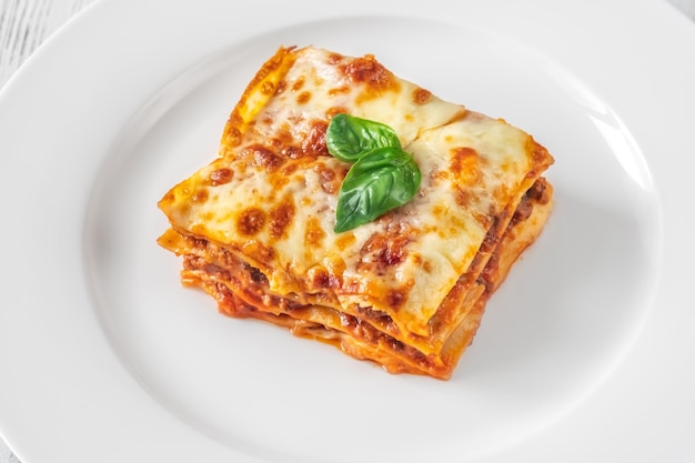 Portion of lasagne on white plate