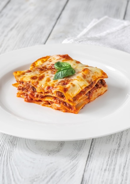 Portion of lasagne on white plate