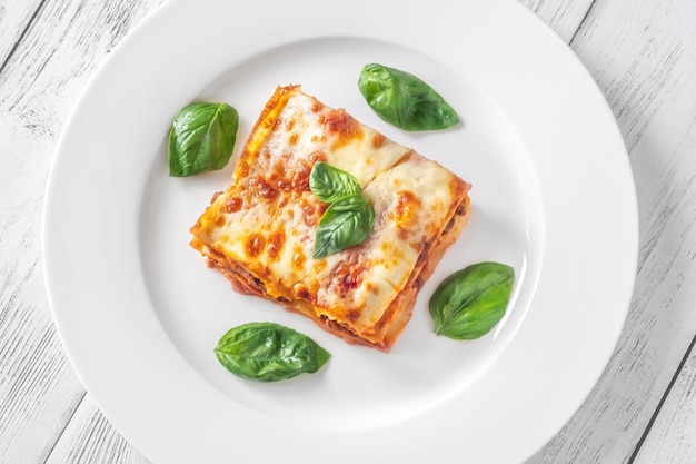 Portion of lasagne on white plate