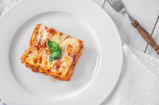 Portion of lasagne on white plate