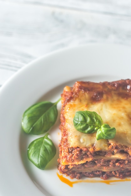 Portion of lasagne on the wooden table