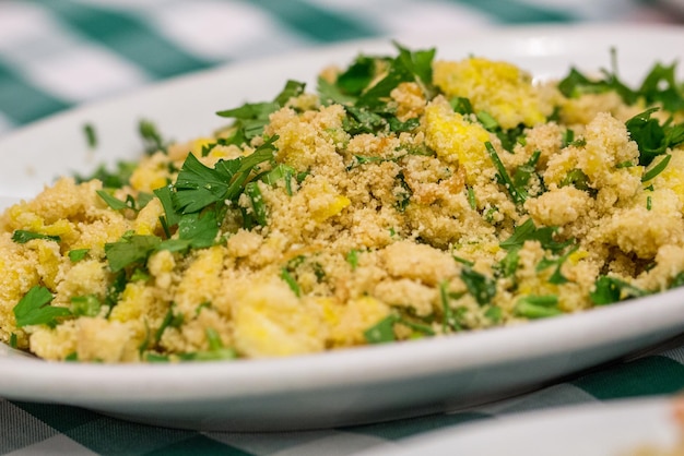 Portion of manioc farofa with eggs typical Brazilian dish called farofa