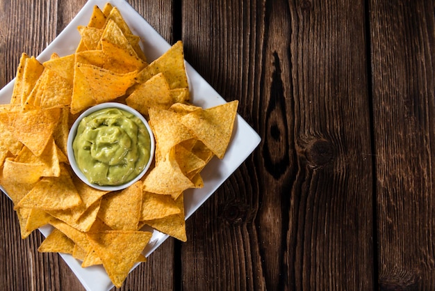 Portion of nachos with guacamole