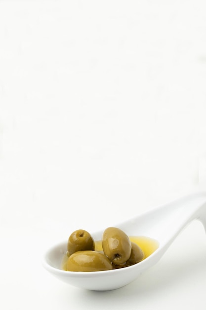 Portion of olives on spoon Copy space