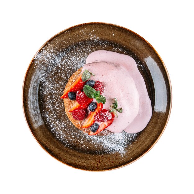 Portion of pancakes with strawberry cream