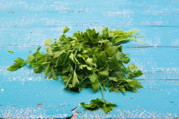 portion of parsley on a wooden board in the kitchen