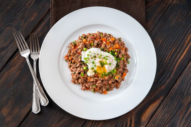 Portion of poached eggs with mince meat