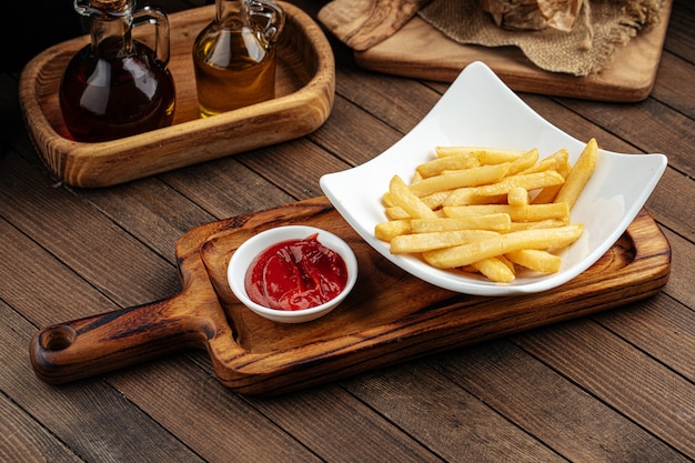 Portion of potato french fries with ketchup