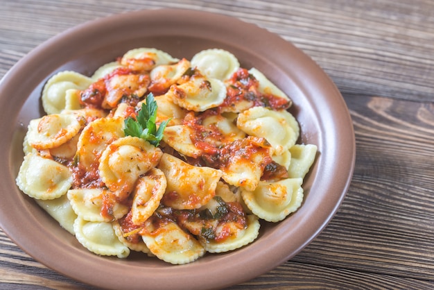 Portion of ravioli with marinara sauce