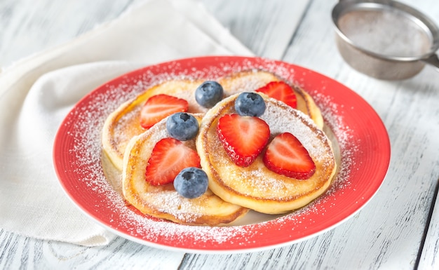 Portion of ricotta fritters with fresh berries