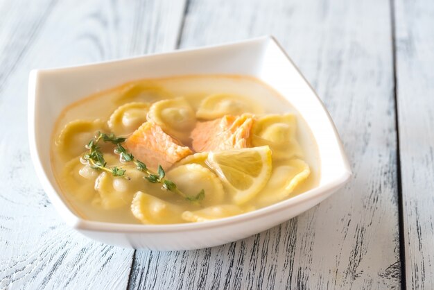 Portion of seafood ravioli soup