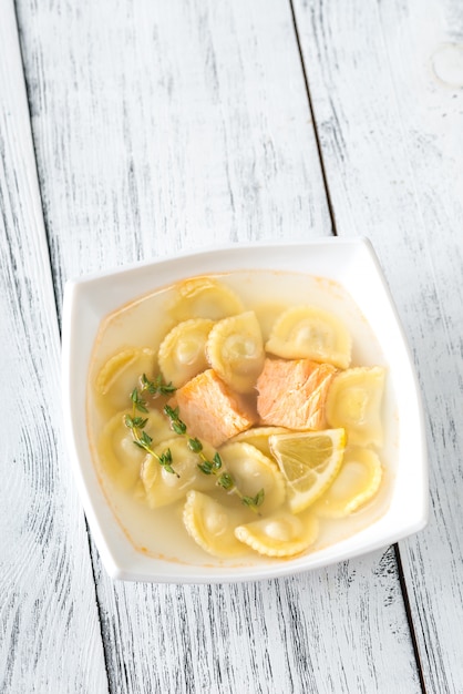 Portion of seafood ravioli soup