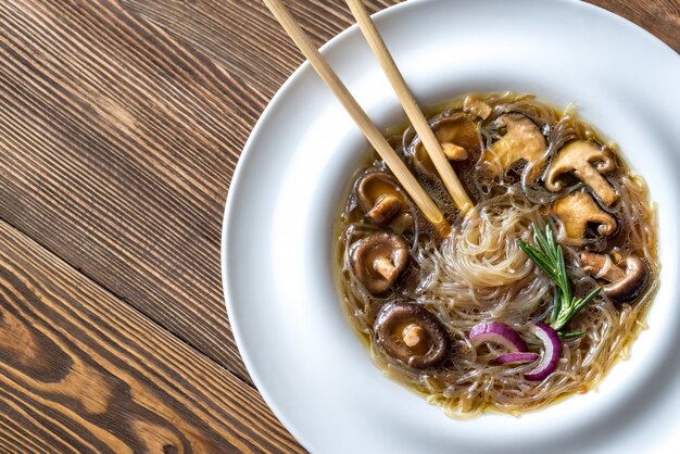 Portion of shiitake ginger soup on the wooden table