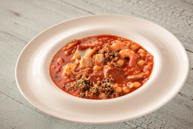 Portion of spanish fish and chorizo soup