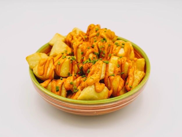 Portion of Spanish patatas bravas with spicy sauce