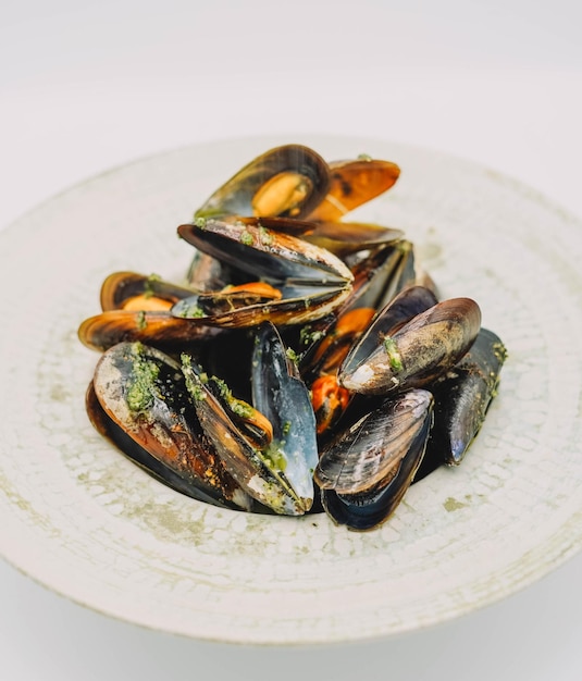 A portion of steamed mussels with garlic and parsley