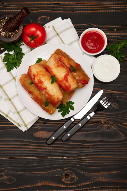 Portion of stuffed cabbage rolls on wooden table