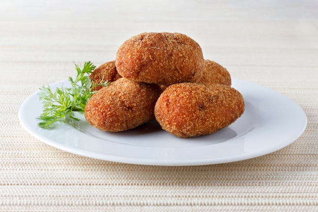 Portion of stuffed fried croquettes on a plate