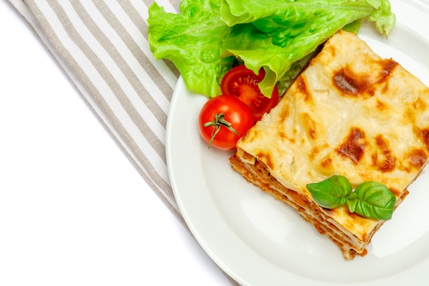 Portion of tasty lasagna isolated on white