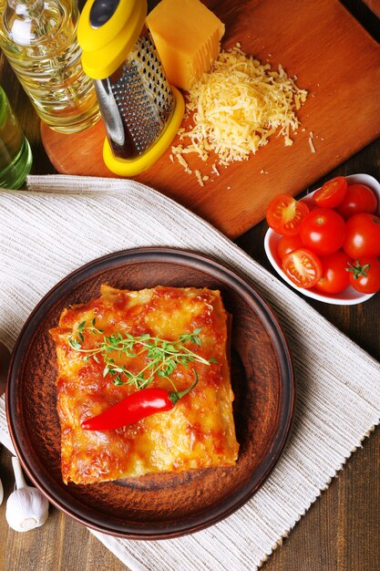 Photo portion of tasty lasagna on table