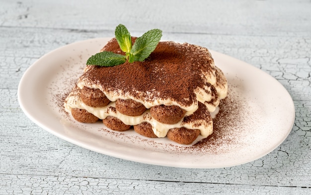 Portion of tiramisu on white serving plate