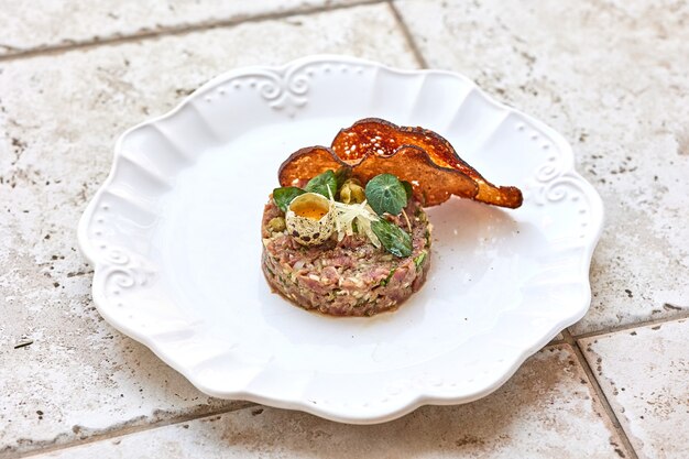 Portion of tuna fish tartare on white plate