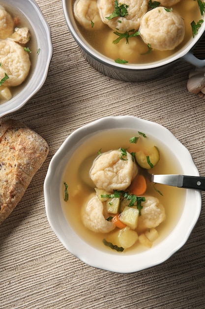 Portions of delicious chicken and dumplings on dining table