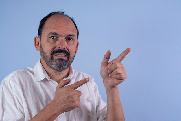 Portrait of 60 years old bearded man on blue background