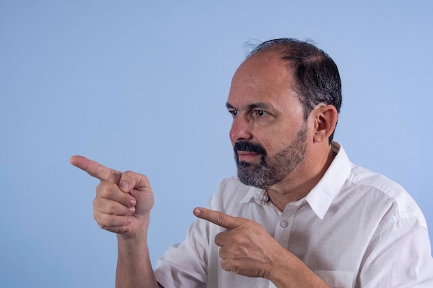 Portrait of 60 years old bearded man on blue background