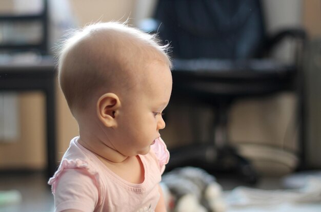 Portrait of an 8 month old girl touching and cute indoor photo solar lighting portrait in profile