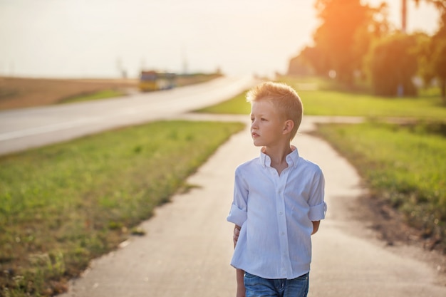 Portrait of achild on the road in the sunny day