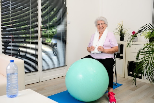 Portrait of an active and dynamic senior woman doing sport fitness at home