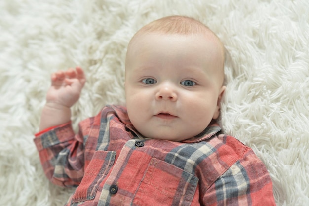 Portrait of adorable baby boy on background