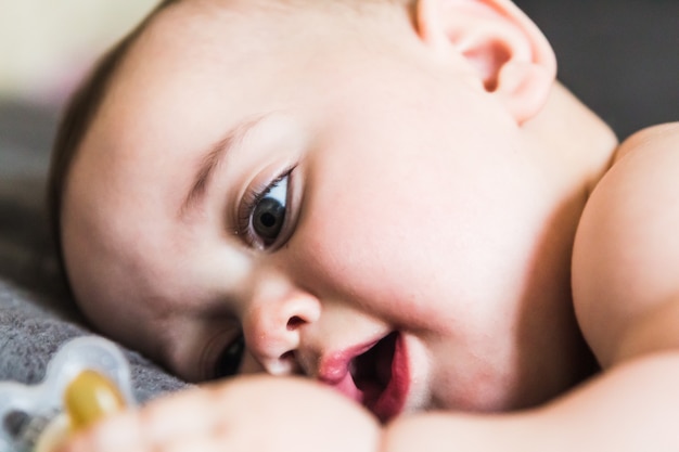 Portrait of adorable baby lying