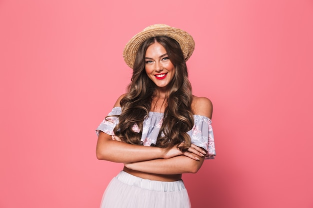 Portrait of adorable glamour woman wearing straw hat smiling and looking at you with arms crossed