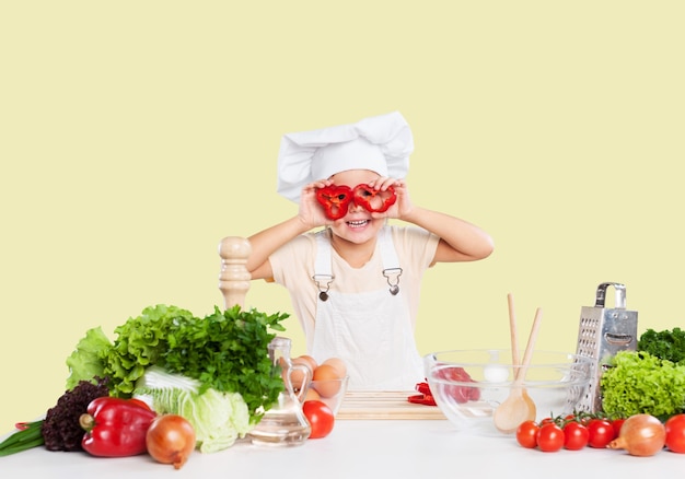 Portrait of adorable little girl preparing healthy food at kitchen