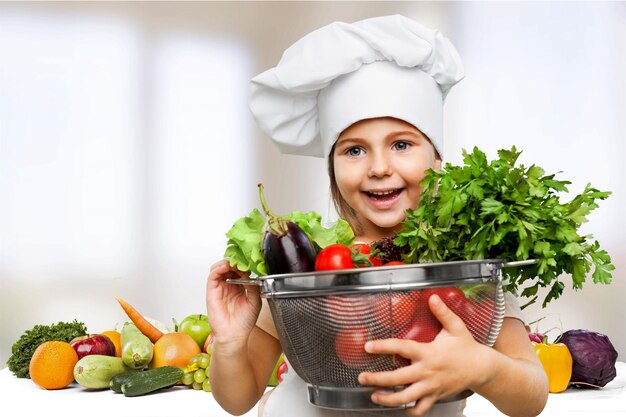 Portrait of adorable little girl preparing healthy food at kitchen