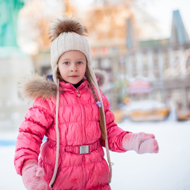 Portrait of adorable little girl on skating rink