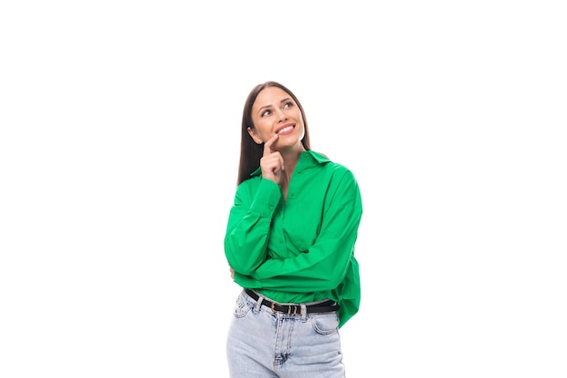 Portrait of an adorable slim cute browneyed brunette woman dressed in a green shirt smiling on white