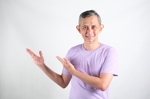 Portrait of Adult Asian Man pointing hands and finger to the side explain something