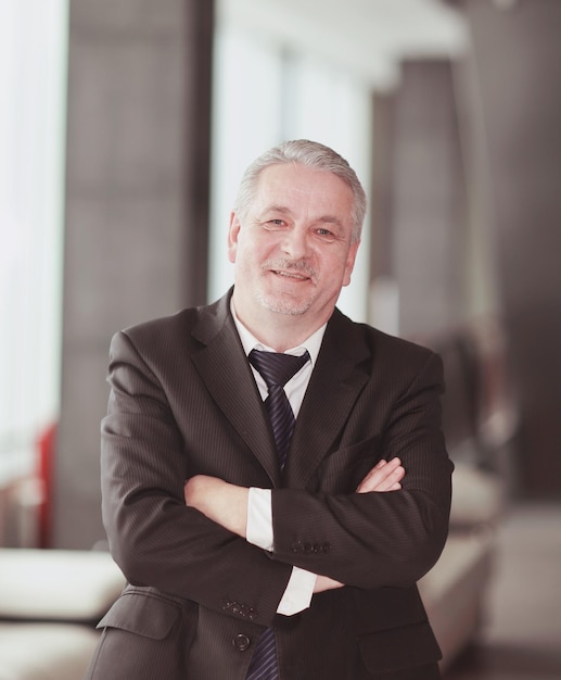 Portrait of an adult businessman on office background