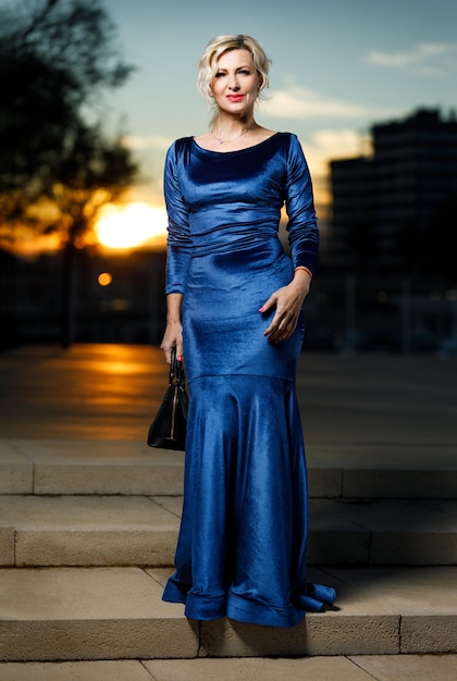 Portrait of adult fashionable elegant woman in evening city