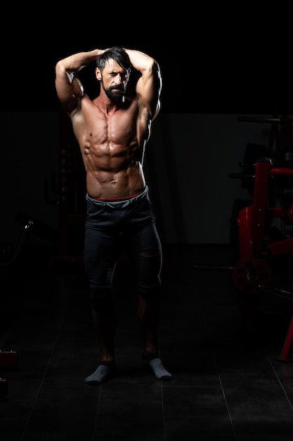 Portrait Of A Adult Physically Fit Man Showing His Well Trained Body - Muscular Athletic Bodybuilder Fitness Model Posing After Exercises