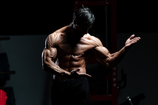 Portrait Of A Adult Physically Fit Man Showing His Well Trained Body - Muscular Athletic Bodybuilder Fitness Model Posing After Exercises