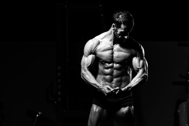 Portrait Of A Adult Physically Fit Man Showing His Well Trained Body - Muscular Athletic Bodybuilder Fitness Model Posing After Exercises