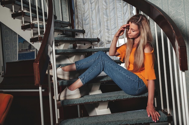 Portrait adult woman actress posing on home staircase