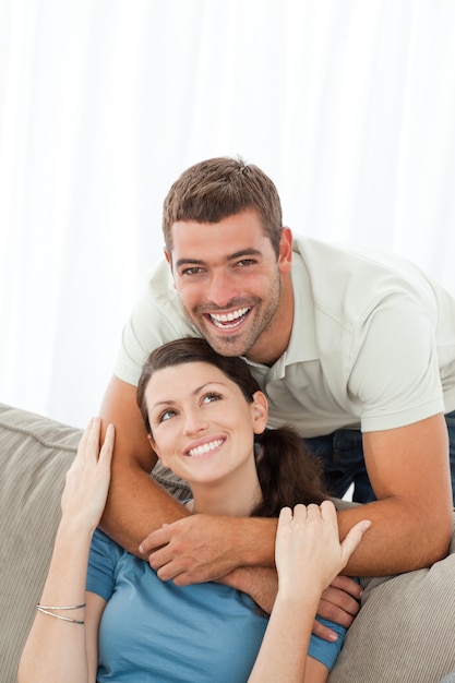 Portrait of an affectionate man with his girlfriend in the living-room