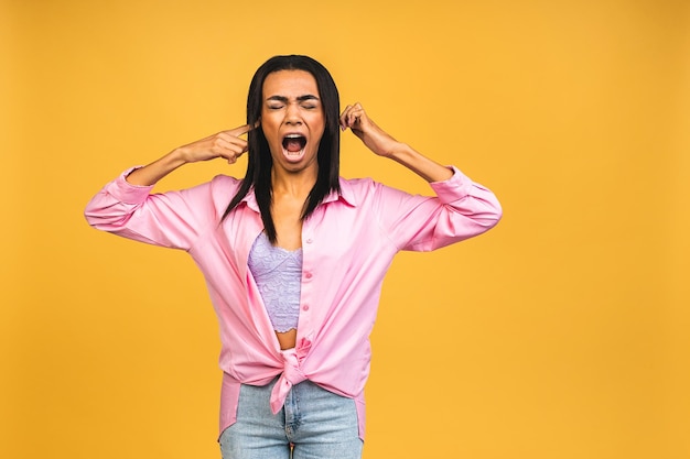 Portrait of african american black woman wearing casual depressed and worry for distress crying angry and afraid sad expression isolated over yellow background